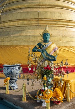 a Figure at the Chedi of the Golden Mount at Wat Saket in the city of Bangkok in Thailand.  Thailand, Bangkok, December, 10, 2023 clipart