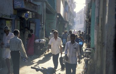 people at a small alley in the city of Chennai in Province Tamil Nadu in India.  India, Chennai, April, 1998 clipart