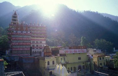 Hindu Hermitage or Monastery of Ashram at the Holy Ganges River in the city of Rishikesh in the Province Uttarakhand in India.  India, Rishikesh, February, 1998 clipart