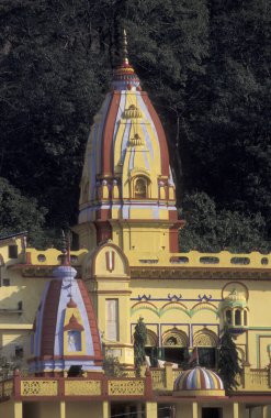 Hindu Hermitage or Monastery of Ashram at the Holy Ganges River in the city of Rishikesh in the Province Uttarakhand in India.  India, Rishikesh, February, 1998 clipart