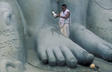 Feet of Gomateshwara Buddha Statue on the Vindhyagiri Hill in the town of Shravanbelagola in the Province of Karnataka in India.   clipart