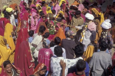 Geleneksel giyinmiş Rajasthani halkı, Hindistan 'ın Rajasthan ilindeki Pushkar kasabasında düzenlenen geleneksel cenaze töreninden sonra evlerine dönüyorlar. Hindistan, Pushkar, Ocak 1998