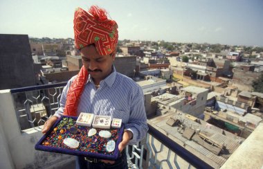 The Boss of a  Gemstone Trading company and Factory of gemstone cutting in the City of Jaipur in the Province of Rajasthan in India.  India, JAIPUR, January, 1998 clipart