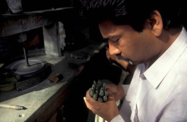 Working People in a Factory of gemstone cutting in the City of Jaipur in the Province of Rajasthan in India.  India, JAIPUR, January, 1998 clipart