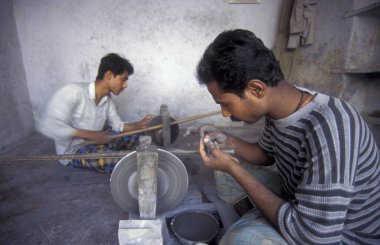 Working People in a Factory of gemstone cutting in the City of Jaipur in the Province of Rajasthan in India.  India, JAIPUR, January, 1998 clipart