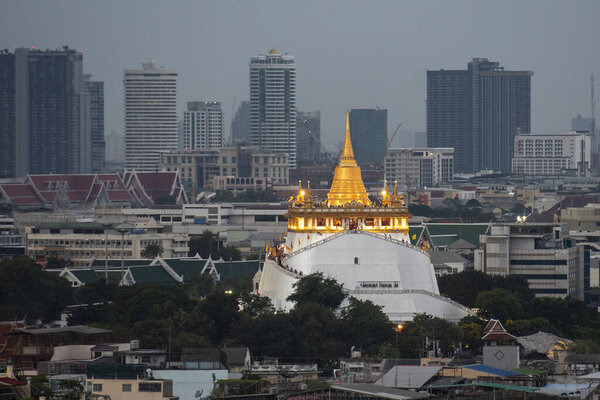 Thailand, Bangkok - November 7, 2024: The Golden Mount Chedi of the Wat Saket with skyline in Bangkok city, Thailand.  