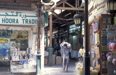BAE, Dubai - 1 Ekim 2004: Souq ve Market in Old Town ve Dubai 'deki Bur Dubai alışveriş caddelerindeki insanlar.  