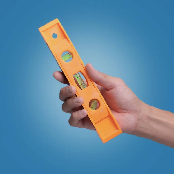 Holding Measure water level tools on blue background