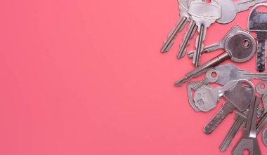 Collection of silver key on pink background