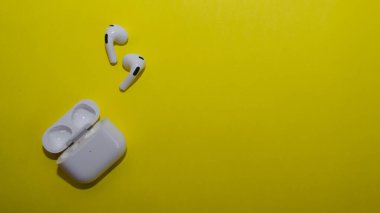 Wireless headphones on a yellow background