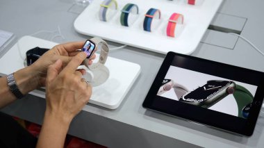 Selection in the electronics store of new smart watches with various applications. The latest technology, buying smart watches in a store with gadgets. Ubud - Indonesia - 2022.