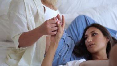 Sensual fingers of the hands of two women who love each other and tenderly relate to their same-sex love. Freedom of women to lesbian relationships. Two beautiful lesbians in bed.