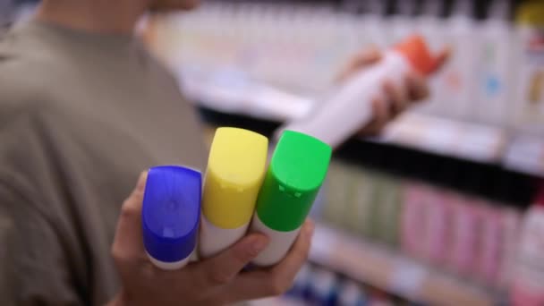 Woman Chooses Hair Shampoo Chooses Different Types Same Brand Different — Stock video