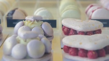 Appetizing cakes and sweet glazed cookies on a shelf in a cookery. Small business retailing culinary products hand-cooked by a culinary chef. Sweets for vegetarians from plant products.