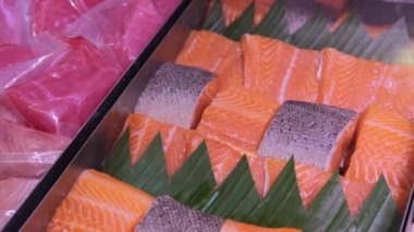 Sale of fish fillets from salmon species, Red dietary fish meat in a supermarket or market. Buying fresh fish to prepare a delicious and healthy salmon dinner that the whole family will enjoy.