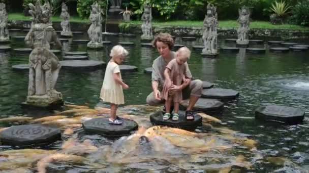 Young Mother Two Daughters Asian Park Feed Fish Pond Large — Vídeo de Stock