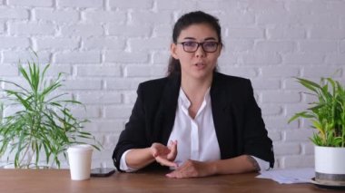 Portrait of remote business coach woman smiling while looking at camera, webcam point of view at home. Teaching students how to video chat. The concept of distance learning. Woman blogger.