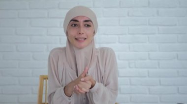 A Muslim woman maintains her blog, tells how to fight for their rights and freedoms of women. A beautiful woman in a hijab tells important messages to the camera for people of different faiths.