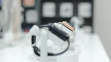 Showcase of an electronics store with a large selection of smart watches and fitness bracelets of different sizes and manufacturers. Buying smart watches is the fashion trend of the future.