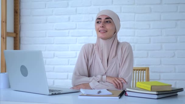 Heureuse Femme Musulmane Dans Hijab Lumineux Assis Bureau Regarde Loin — Video
