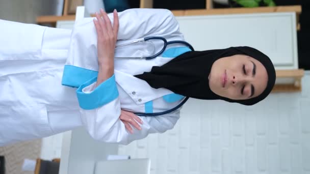 Vídeo Vertical Mulher Muçulmana Médica Tem Braços Cruzados Olha Para — Vídeo de Stock