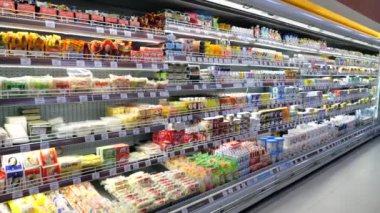 Denpasar, Endonezya - 22 Şubat 2024: Süpermarkette, çeşitli süt ürünleriyle dolu buzdolabı rafları. Süpermarkette geniş seçili süt ürünleri. Süpermarkette alışveriş kalitesi.