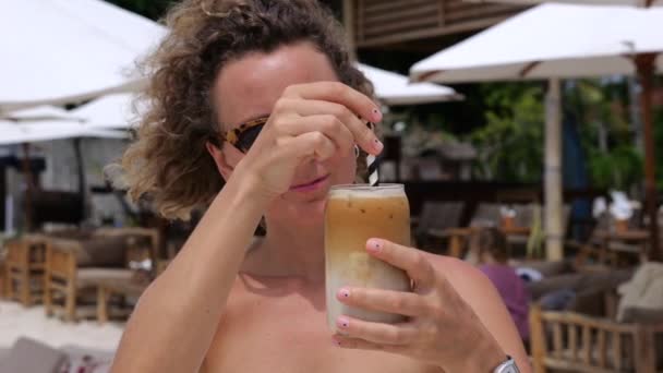 Woman Stirs Iced Coffee Latte Beach Cafe Close Woman Sunglasses — Stock Video