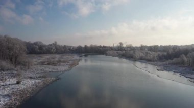 Beautiful frozen river, flying over winter nature