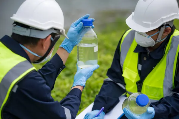 Saving earth. Environmental researchers investigate the condition of canal water for toxic spill, river waste water sampling, Scientist collect water samples for analysis and research on water qualit
