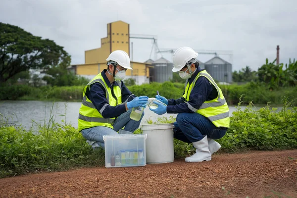 Saving earth. Environmental researchers investigate the condition of canal water for toxic spill, river waste water sampling, Scientist collect water samples for analysis and research on water qualit