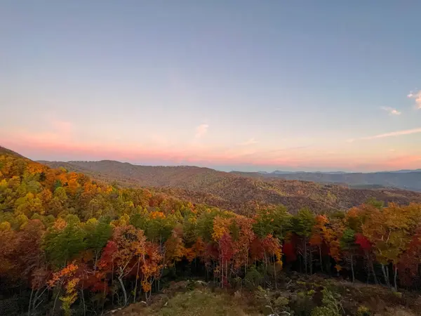 A view of the Blue Ridge Parkway in Boone, NC during the autumn fall color changing season with a sunset.