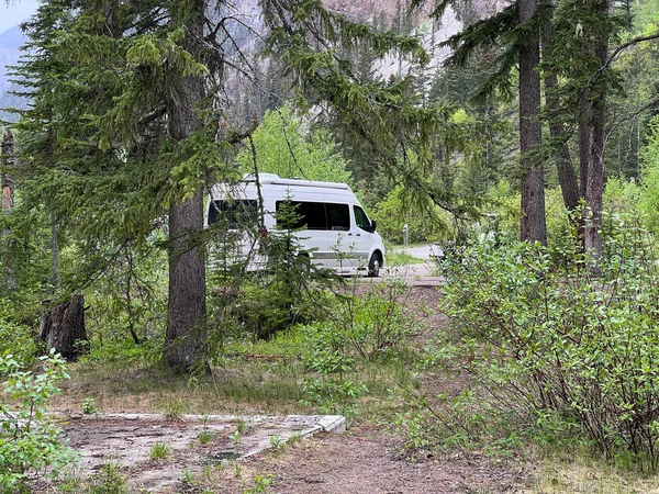 An isolated Van camping in Kicking Horse Campgraound in Yoho National Park in Canada.