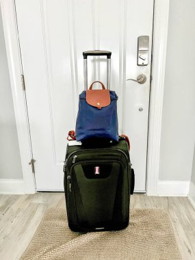 Bir sırt çantası ve bir bavul havaalanına gitmek için hazırlanıyor..