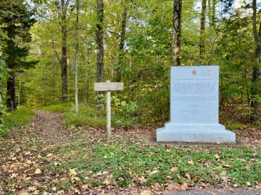 Hohenwald, TN USA - October 9, 2023: A monument explaining the history of the Natchez Trace Parkway along the Natchez Trace Parkway. clipart