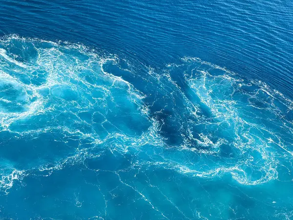 Gemi seyahati güzel güneşli bir günde beyaz bulutlar ve çalkantılı mavi denizlerle Atlantik Okyanusu 'nda uyanır..