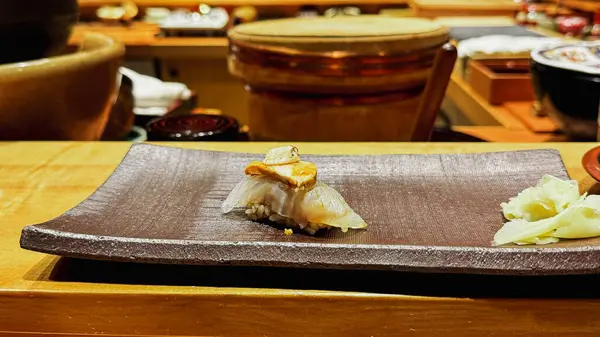 Ankimo (Keşiş Balık Karaciğeri) Nigiri Sushi, Ginger 'la servis edilir. Görüntü editoryal ya da ticari olarak kullanılabilir.