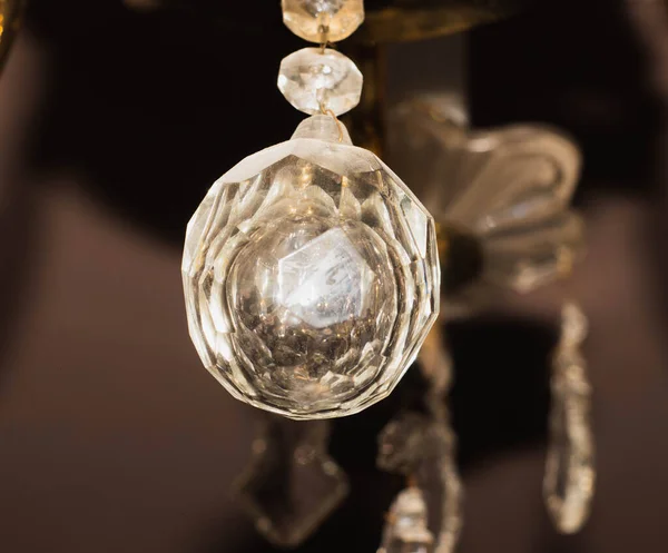 A crystal ball hangs from the chandelier. Crystal chandelier details