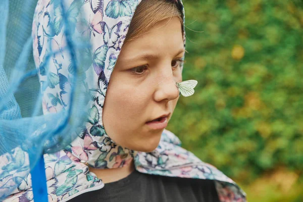 stock image Funny teenager catches a butterfly. Casual moment.