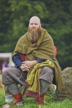 Hojbjerg, Denmark, July 27, 2024: Man in ancient clothing at a Viking festival clipart