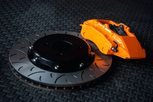 stock image Car mechanic or serviceman disassembly and checking a disc brake and asbestos brake pads for fix and repair problem at car garage or repair shop