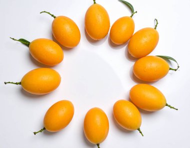 Yapay zeka, parlak su damlacıklarıyla dairesel dizilmiş altın-turuncu akçaağaç meyvelerinin canlı görüntüsünü oluşturdu, pürüzsüz derilerini ve temiz beyaz arka planda taze köklerini sergiledi.