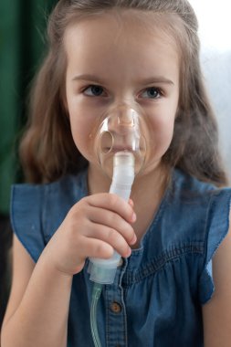 Beyaz kız evde solunum terapisi için astım spreyi kullanıyor..