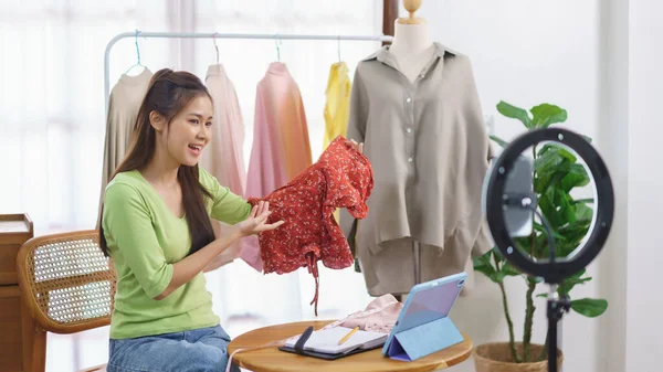 stock image Fashion clothes online concept, Female seller present and sell new collection on live streaming.