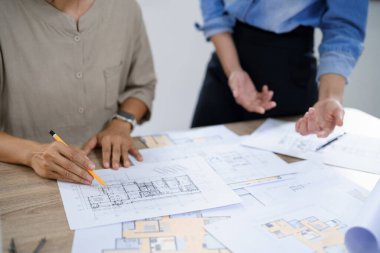 Mühendislik danışmanlığı kavramı, iki kadın mühendis, apartman planlarını tartışıyorlar..