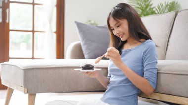 Work from home concept, Business women eats dessert to take a break while working remotely at home.
