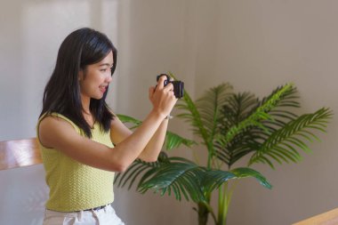 Hand embroidery concept, Women using camera to taking photo handicraft in embroidery workshop.