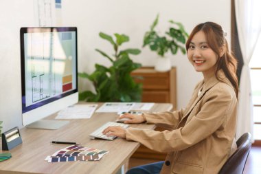 Architecture concept, Female architect working about designing house interior project on computer.