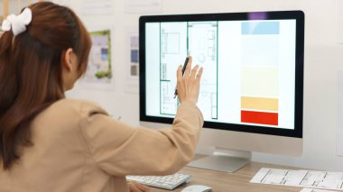 Architectural concept, Female architect checking about plan of designing house interior on computer.