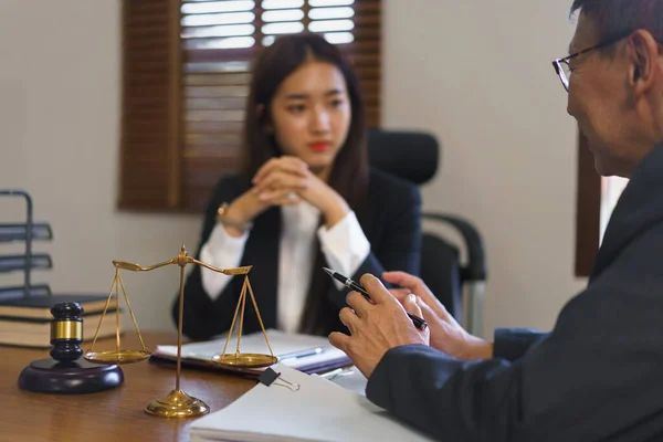 Legal and justice concept, Senior lawyer explains and provide legal advice to young female lawyer.