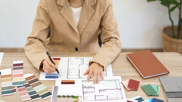 stock image Architecture concept, Female architect selecting color and designing house interior in blueprint.